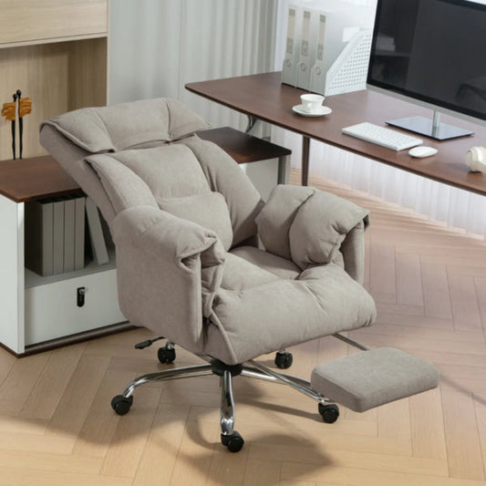 Beige ergonomic office chair with padded armrests and footrest in modern home office setting